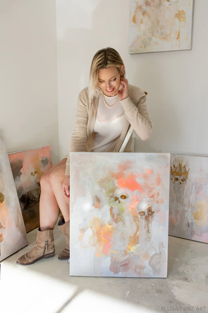 Artist Lisa Penz with her new abstract painting, featuring skulls in warm neutrals. California
