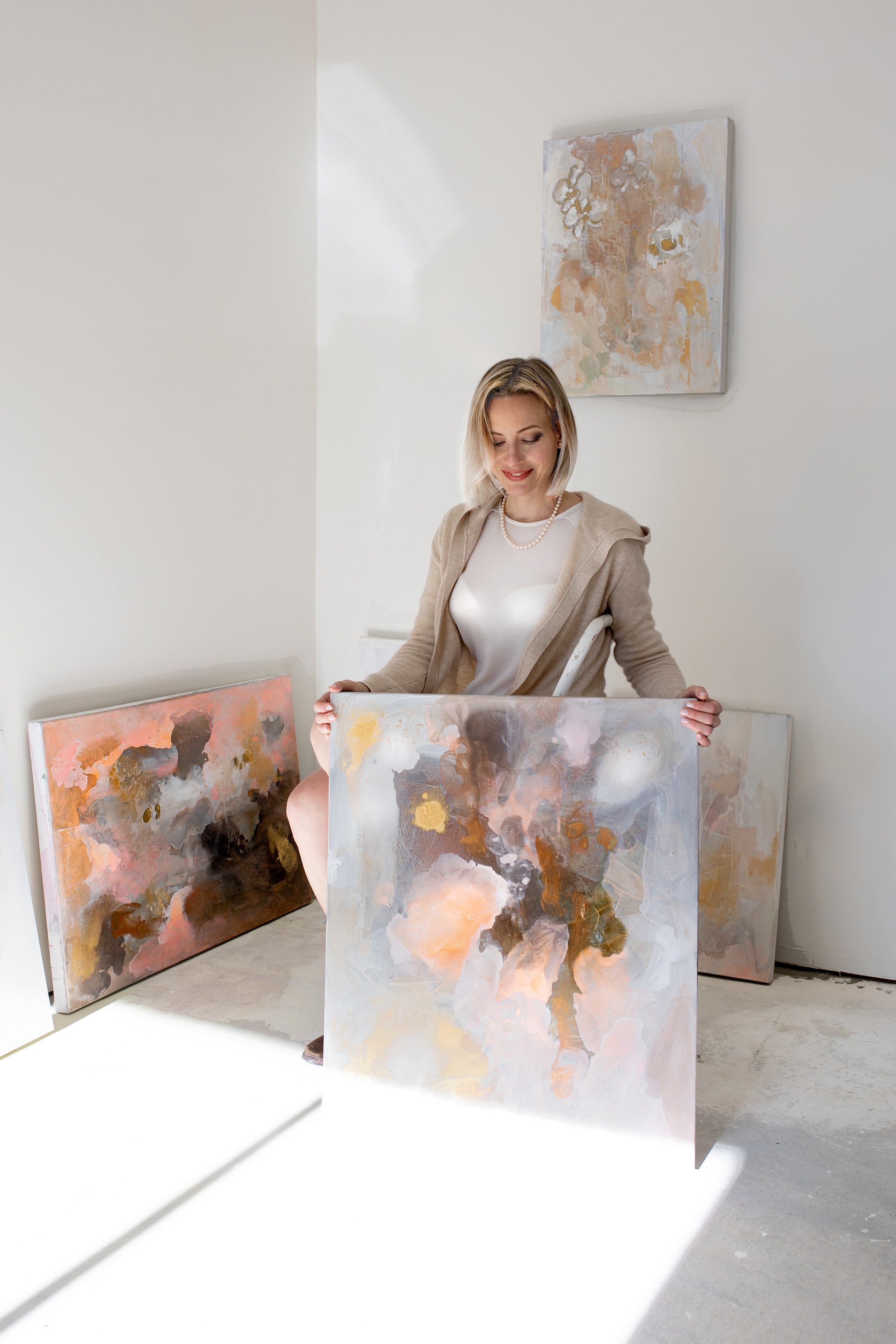 Female artist Lisa Penz with abstract painting for living room palm beach south florida